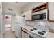 Kitchen features white appliances and ample counter space at 1126 W Elliot Rd # 1058, Chandler, AZ 85224