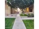 Paved walkway meandering through lush green landscaping at 1126 W Elliot Rd # 1058, Chandler, AZ 85224