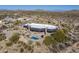 Aerial view of modern home with pool, desert landscape, and distant mountains at 11501 E Mark Ln, Scottsdale, AZ 85262