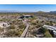 Aerial view of luxury home with long private driveway and desert landscape at 11501 E Mark Ln, Scottsdale, AZ 85262