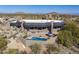 Aerial view of a luxury home with a pool and desert landscape at 11501 E Mark Ln, Scottsdale, AZ 85262