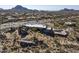 Aerial view of a home nestled in the desert landscape, near large rocks at 11501 E Mark Ln, Scottsdale, AZ 85262