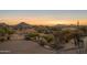 Landscaped backyard with mountain views at sunset at 11501 E Mark Ln, Scottsdale, AZ 85262