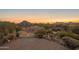 Landscaped backyard with circular paver patio and mountain views at 11501 E Mark Ln, Scottsdale, AZ 85262