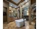 Spa-like bathroom with soaking tub and granite finishes at 11501 E Mark Ln, Scottsdale, AZ 85262