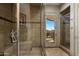 Spa-like bathroom with glass shower, stone tile, and desert views at 11501 E Mark Ln, Scottsdale, AZ 85262