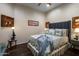 Guest bedroom with dark wood floors, and a plush bed with pillows and throw at 11501 E Mark Ln, Scottsdale, AZ 85262