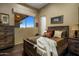 Bedroom with rustic wood furniture and a window overlooking scenic landscape at 11501 E Mark Ln, Scottsdale, AZ 85262