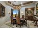 Formal dining room with ornate furniture and a large painting, showcasing natural light at 11501 E Mark Ln, Scottsdale, AZ 85262