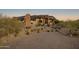 Luxury home with a circular driveway and desert landscaping at 11501 E Mark Ln, Scottsdale, AZ 85262