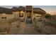 Front entrance with stone steps and desert landscaping at 11501 E Mark Ln, Scottsdale, AZ 85262