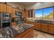 Spacious kitchen with granite countertops and stainless steel appliances at 11501 E Mark Ln, Scottsdale, AZ 85262