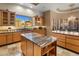 Island kitchen with granite countertops, ample cabinet space, and breakfast bar at 11501 E Mark Ln, Scottsdale, AZ 85262