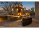 Cozy outdoor fireplace with seating area, perfect for relaxing evenings at 11501 E Mark Ln, Scottsdale, AZ 85262