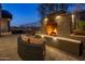 Elegant outdoor fireplace and seating area at night at 11501 E Mark Ln, Scottsdale, AZ 85262