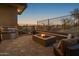 Entertaining outdoor kitchen with built-in grill and fire pit at 11501 E Mark Ln, Scottsdale, AZ 85262