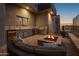 Luxury outdoor kitchen, fire pit, and seating area at 11501 E Mark Ln, Scottsdale, AZ 85262