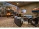 Covered patio with fireplace, seating area, and outdoor TV at 11501 E Mark Ln, Scottsdale, AZ 85262