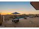 Patio area with pool, spa, dining furniture, and sunset views at 11501 E Mark Ln, Scottsdale, AZ 85262