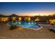 Beautiful pool and spa at dusk, mountain backdrop at 11501 E Mark Ln, Scottsdale, AZ 85262