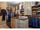 Large walk-in closet with ample shelving and hanging space at 11501 E Mark Ln, Scottsdale, AZ 85262