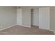 Bedroom with sliding door closet and carpet flooring at 11616 N 30Th Ln, Phoenix, AZ 85029