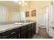 Bathroom with granite countertop, dark wood cabinets, and shower/tub combo at 11971 E Chevelon Trl, Gold Canyon, AZ 85118