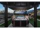 Hot tub under a pergola in a landscaped backyard at 11971 E Chevelon Trl, Gold Canyon, AZ 85118