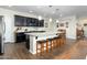 Modern kitchen with granite island and dark wood cabinets at 11971 E Chevelon Trl, Gold Canyon, AZ 85118