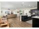 Open concept kitchen and living area with dark cabinets at 11971 E Chevelon Trl, Gold Canyon, AZ 85118