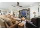 Living room with a large sectional sofa, wood-look tile floors, and rustic decor at 11971 E Chevelon Trl, Gold Canyon, AZ 85118