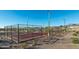 Community pickleball courts with chain link fencing and outdoor lighting at 11971 E Chevelon Trl, Gold Canyon, AZ 85118