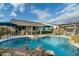 Large kidney-shaped pool surrounded by a spacious patio and lush landscaping at 11971 E Chevelon Trl, Gold Canyon, AZ 85118