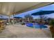 Relaxing pool area with patio cover and multiple umbrellas at 11971 E Chevelon Trl, Gold Canyon, AZ 85118