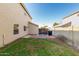 Small backyard with grassy area, block wall, and gated access at 1209 N Newport St, Chandler, AZ 85225