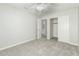 Bright bedroom with ceiling fan, neutral walls, and gray carpet at 1209 N Newport St, Chandler, AZ 85225