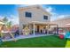 The backyard features a covered patio and artificial turf for low-maintenance outdoor living at 12378 W Roma Ave, Avondale, AZ 85392