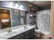 Bathroom featuring double sinks, vanity, a toilet, and a shower with a decorative curtain at 12378 W Roma Ave, Avondale, AZ 85392