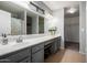 Bathroom vanity with drawers and shelving, and a large mirror at 12378 W Roma Ave, Avondale, AZ 85392