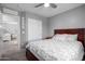 Comfortable bedroom boasts a ceiling fan and ample natural light from the window at 12378 W Roma Ave, Avondale, AZ 85392
