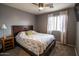 Bedroom featuring a bed with floral patterned covers, neutral colors, and a large window at 12378 W Roma Ave, Avondale, AZ 85392