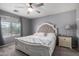 Cozy bedroom with a large window, soft carpet, and a beautifully tufted headboard at 12378 W Roma Ave, Avondale, AZ 85392