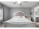 Comfortable bedroom with neutral walls, ceiling fan, and a luxuriously upholstered bed at 12378 W Roma Ave, Avondale, AZ 85392