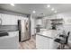Modern kitchen with stainless steel appliances, white cabinetry, and stylish island with breakfast bar at 12378 W Roma Ave, Avondale, AZ 85392