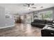 Spacious open-concept living room with wood floors and a dining area at 12378 W Roma Ave, Avondale, AZ 85392