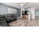 Comfortable living room with a ceiling fan, wood floors, and a large sectional couch at 12378 W Roma Ave, Avondale, AZ 85392