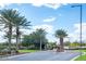 Landscaped entrance to a community with palm trees and a gated entryway at 13360 W Red Hawk Dr, Peoria, AZ 85383