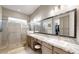 Double vanity bathroom with a large mirror and walk-in shower at 13360 W Red Hawk Dr, Peoria, AZ 85383