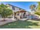 Relaxing backyard with covered patio, BBQ, and lush landscaping at 14206 W Mandalay Ln, Surprise, AZ 85379