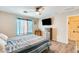 Primary bedroom with striped bedding and wood dresser at 14206 W Mandalay Ln, Surprise, AZ 85379